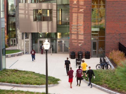 Students walking outside the Integrated Sciences Building