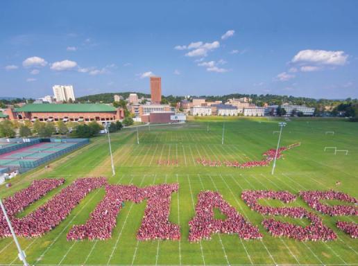 Hundreds in the UMass community forming the word "UMass" on a field