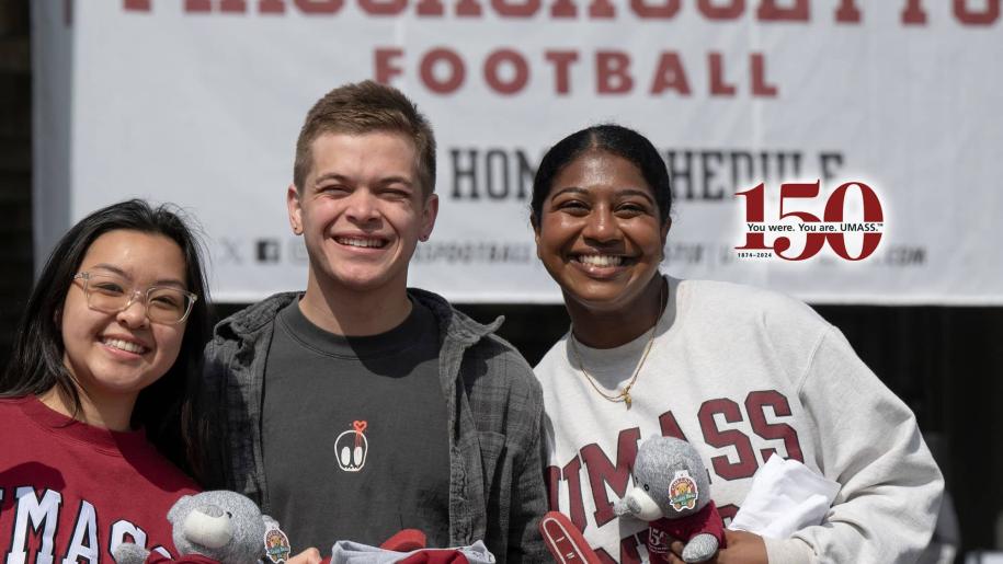 Group of students posed, wearing UMass gear