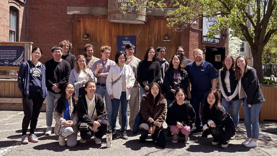 Group of UMass alums posed outside of brewery